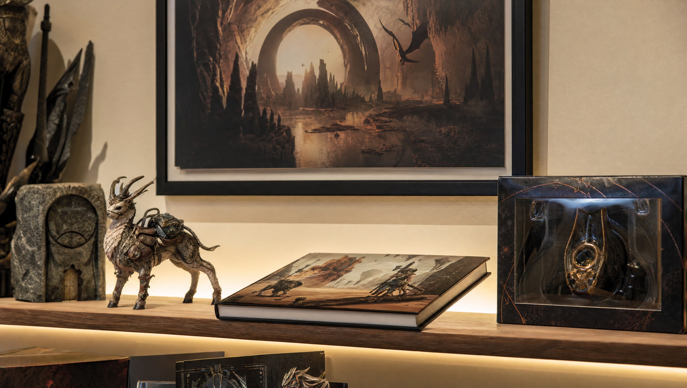 A framed invented game poster on a cream wall with a lit shelf of merchandise beneath it.
